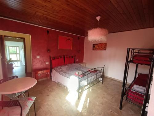 a bedroom with a bed and a table and chairs at La casa sul tetto, Room's & Glamping in Recanati