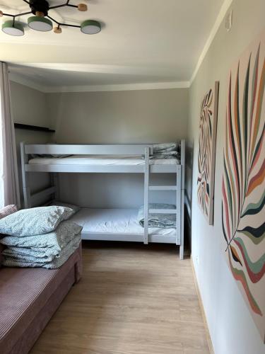 a bedroom with two bunk beds and a ceiling at Oto Domek 1 in Międzyrzecz