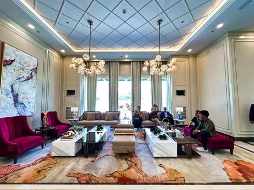 a group of people sitting in a lobby at 2 BR 5 pax Spacious Elegant Condo in Saint Dominique, Megaworld, Iloilo City in Iloilo City