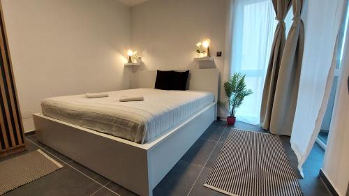 a bedroom with a large bed in a room at Orchidea apartman in Balatonalmádi