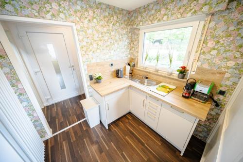 a small kitchen with a sink and a window at Höri-Nest Seeblick-Appartement in Gaienhofen