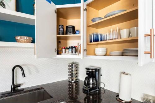 a kitchen with white cabinets with dishes on shelves at 2 bedroom home in Dayton in Dayton