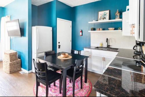a kitchen with blue walls and a black table and chairs at 2 bedroom home in Dayton in Dayton