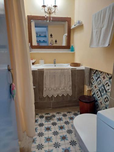 a bathroom with a sink and a mirror at Elies apartments 2 in Alinda