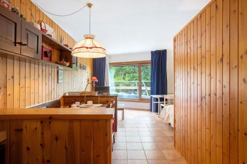 a kitchen with wood paneled walls and a large island at Appartamenti Larice Pila in Pila