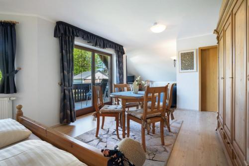 a living room with a table and chairs and a bedroom at Pension Bergblick in Marienberg