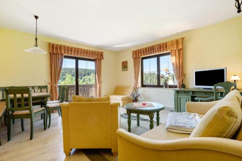 a living room with a couch and a table at Pension Bergblick in Marienberg