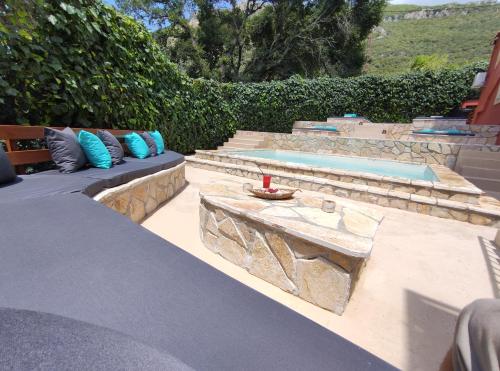 a patio with a bench and a swimming pool at GKK House private swimming pool luxury house in Skriperón