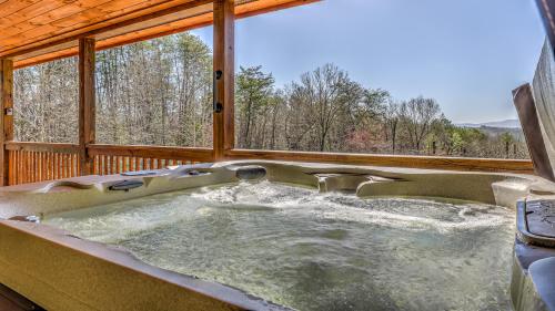 a jacuzzi tub in a log cabin at Tranquility Ranch in Mineral Bluff