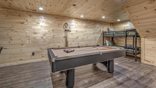 a pool table in a room with wooden walls at Tranquility Ranch in Mineral Bluff
