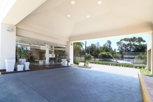 an empty lobby of a building with a large window at Holiday Inn Tijuana Zona Rio by IHG in Tijuana