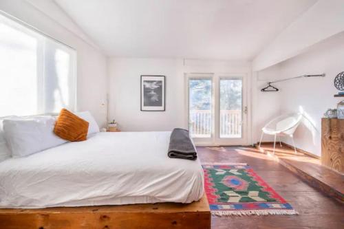 a bedroom with a large bed and a rug at Serene Catskills Retreat with Deck in Woodbourne
