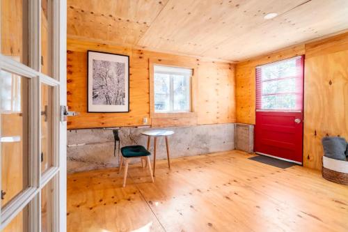 a room with a red door and a chair at Serene Catskills Retreat with Deck in Woodbourne