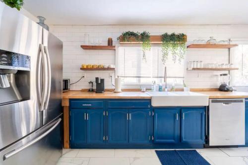 a kitchen with blue cabinets and a stainless steel refrigerator at Serene Catskills Retreat with Deck in Woodbourne