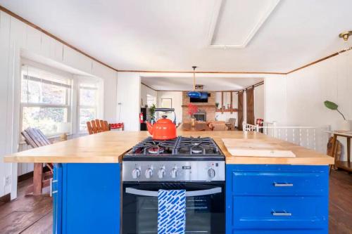 a kitchen with a stove and a blue island at Serene Catskills Retreat with Deck in Woodbourne