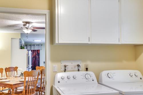 a kitchen with white appliances and a table with chairs at 10 Mi to Silverwood Secluded Getaway! in Spirit Lake
