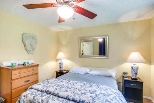 a bedroom with a bed and a ceiling fan at 10 Mi to Silverwood Secluded Getaway! in Spirit Lake