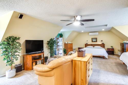 a living room with a bed and a couch at 10 Mi to Silverwood Secluded Getaway! in Spirit Lake