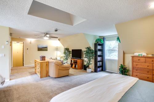 a bedroom with a bed and a couch and a desk at 10 Mi to Silverwood Secluded Getaway! in Spirit Lake