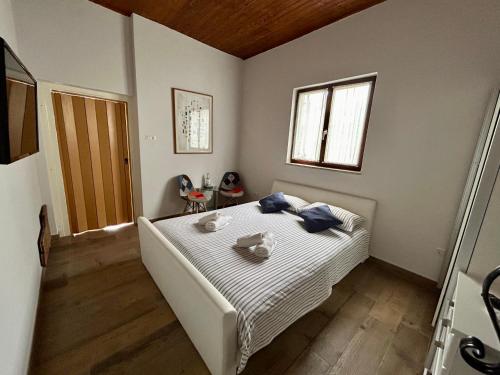 a bedroom with a large white bed with blue pillows at Apartman Maslina in Poreč