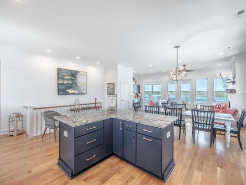 a kitchen and dining room with a table and chairs at Channel 6 in Surf City