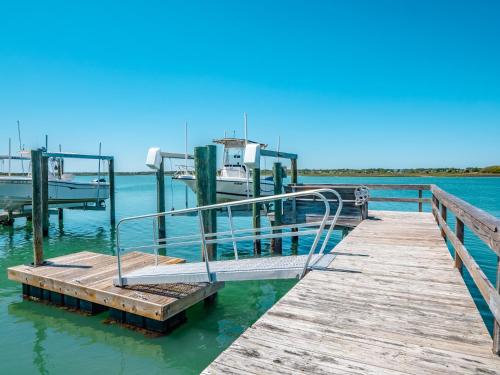 a dock with a boat in the water at Channel 6 in Surf City