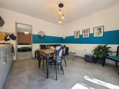 a kitchen and dining room with a table and chairs at La Dame de cœur 05 in Antonaves