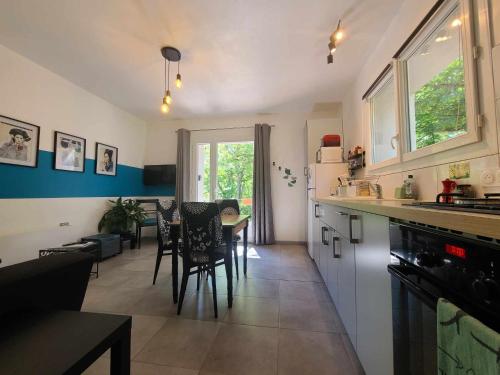 a kitchen and dining room with a table and chairs at La Dame de cœur 05 in Antonaves