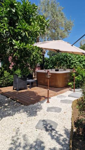 a patio with a table and an umbrella at Casa della Zagara in Acireale