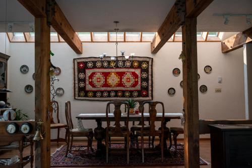 a dining room with a table and chairs and a rug at Mountain Springs Nature Retreat in Kaleden