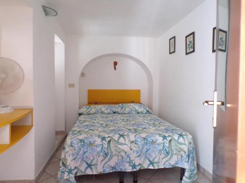 a bedroom with a bed in a white room at L'Isolana Case Vacanza Alloro 1 in Ponza