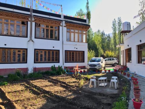 a house with a yard in front of it at Sponbo Guest House, Leh in Leh
