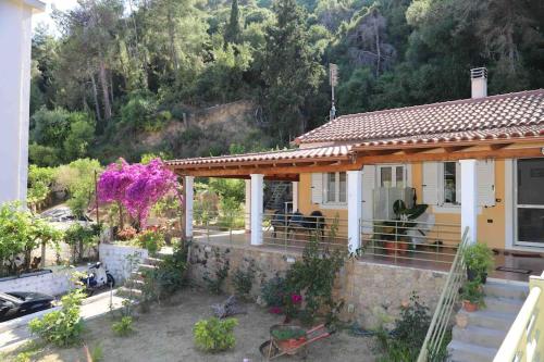 a small house with a porch at Demar Rooms & Apartments in Katakolon