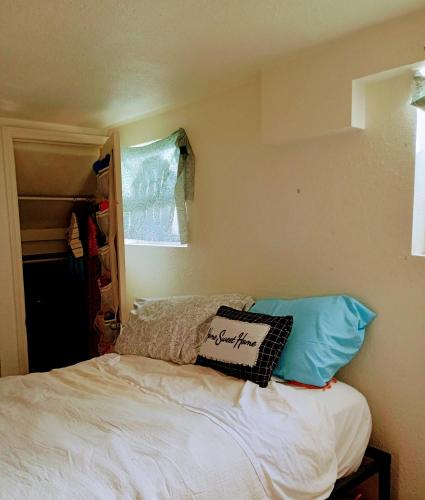 a bedroom with a bed with pillows and a window at Big Horn Motel in Cheyenne