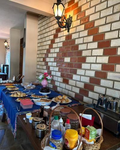 a table with a blue table cloth with food on it at Pousada Aconchego in Pirenópolis