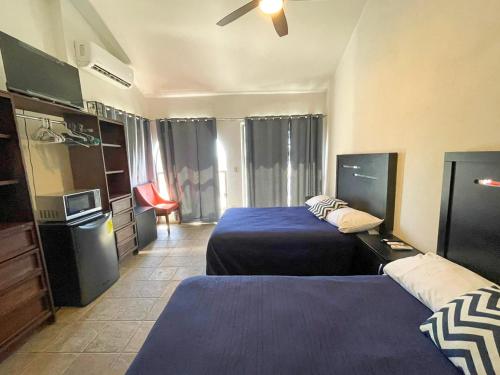 Cama o camas de una habitación en Hostal las Quintas