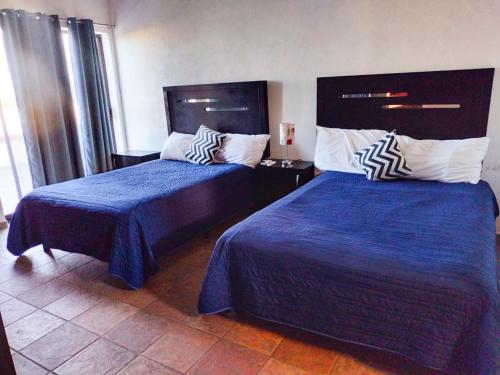 Cama o camas de una habitación en Hostal las Quintas