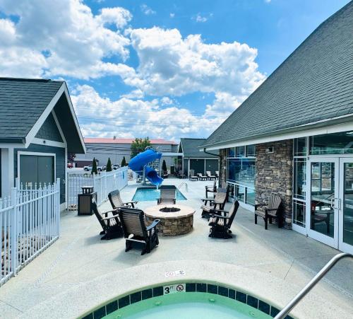a patio with chairs and a table and a pool at The Walden, Trademark Collection By Wyndham in Pigeon Forge