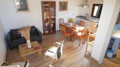 a living room and kitchen with a table and chairs at Capalbio - Retreat in Capalbio