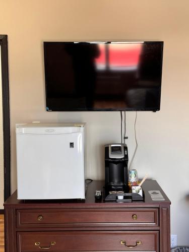 a flat screen tv sitting on top of a dresser at King Hotel in Oliver