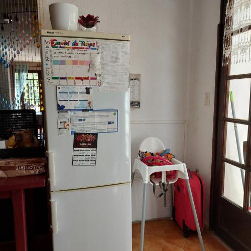 a white refrigerator in a kitchen with a table at Naturetmer4 in Six-Fours-les-Plages
