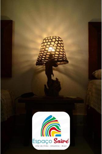 a lamp on top of a tv with a rainbow at Espaço Sairé - 8 minutos da Praia in Alter do Chao