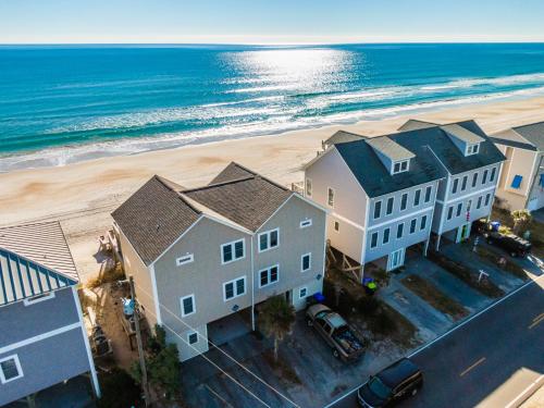 an aerial view of a house and the beach at Daybreak on the Sand in Surf City