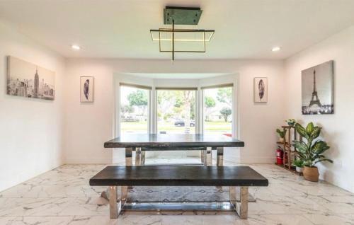 a dining room with a table and a large window at Chic and Secure Private room in modern home 6 in Los Angeles