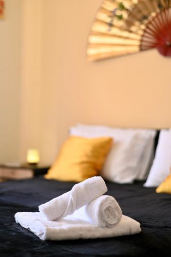 a folded towel on top of a bed at Etna Volcano Relais- Indipendent Villa in Mascalucia