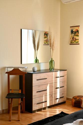 a dresser in a living room with a mirror at Etna Volcano Relais- Indipendent Villa in Mascalucia