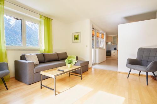 a living room with a couch and a table at Apartments Kirchebnerhof in Oetz