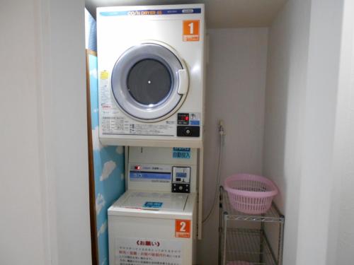 a washer and dryer in a small room at Nishikawaguchi Station Hotel - Vacation STAY 98562v in Kawaguchi