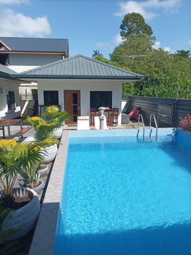 a swimming pool in front of a house at Tropical appartement 2 in Paramaribo