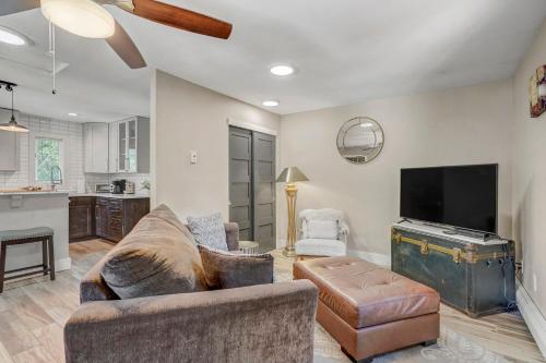 a living room with a couch and a flat screen tv at Red Rock Loft! Trails Apartment w BBQ & Fire Pit in Colorado Springs